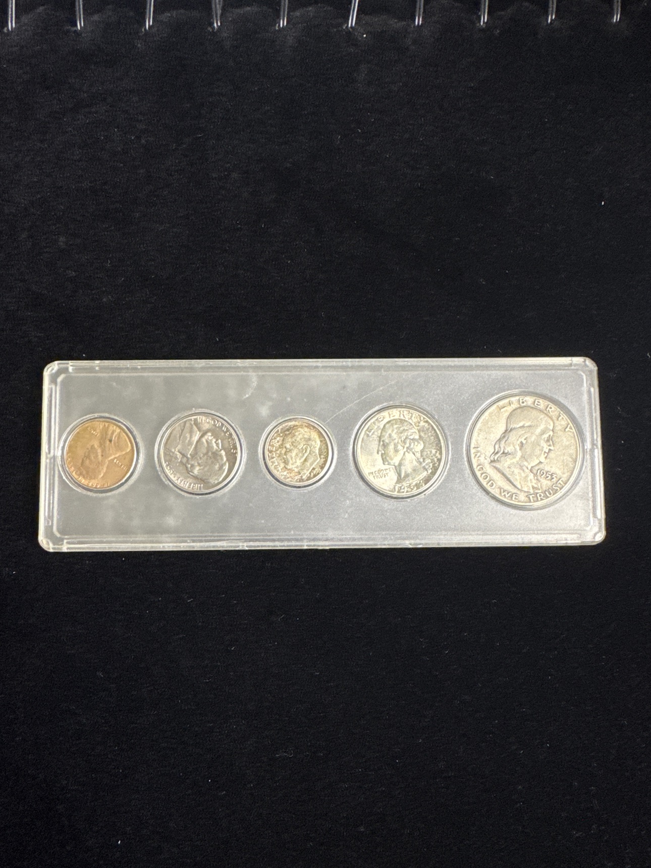 Obverse view of the complete 1953 U.S. proof set in a protective hard plastic holder