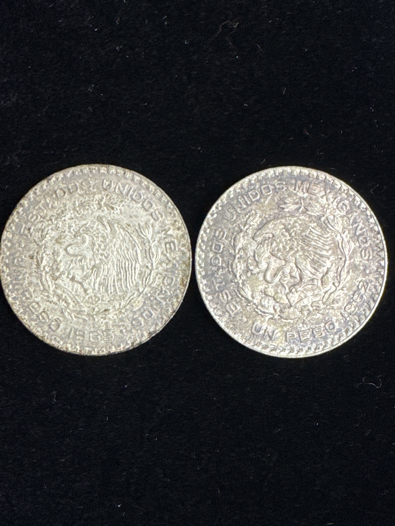 Eagle side of both circulated Mexican one peso silver coins