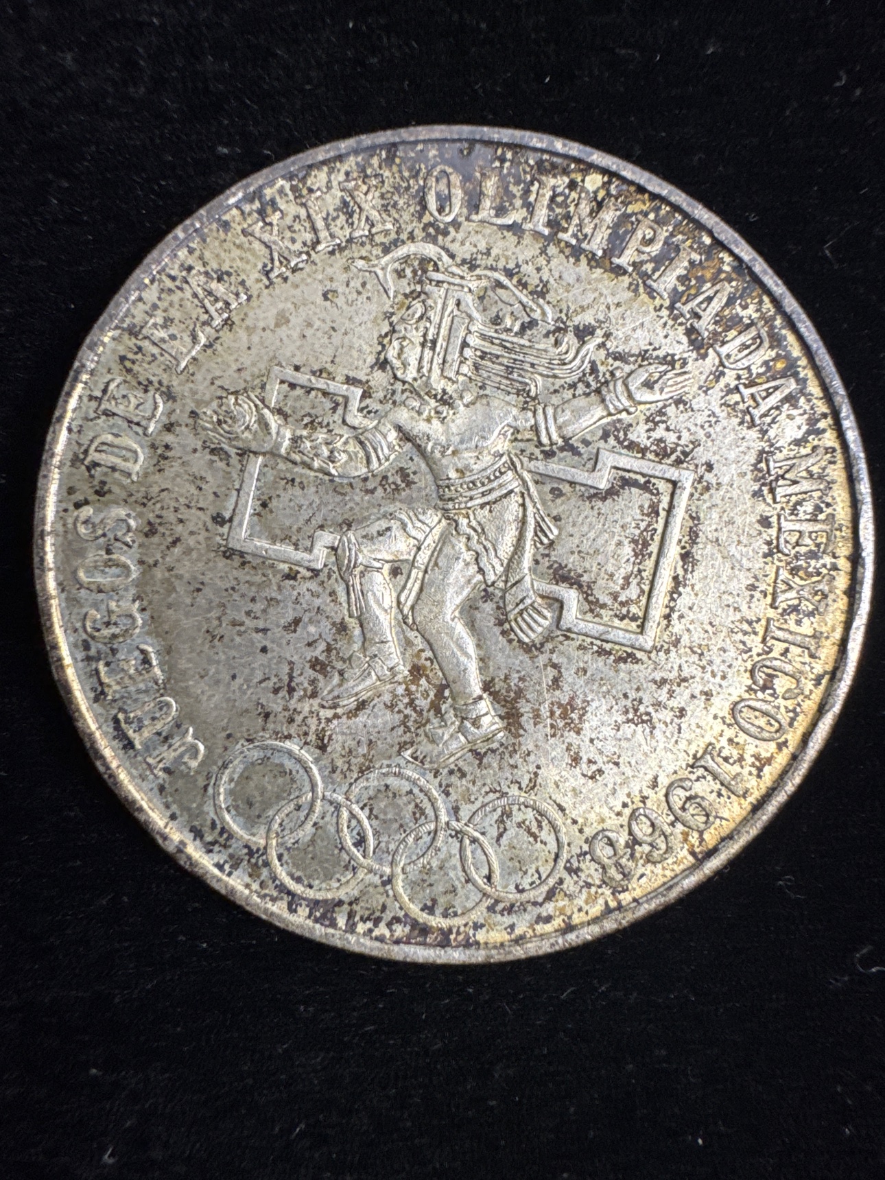 Olympic ball-player side of the circulated 1968 Mexico 25 pesos silver coin